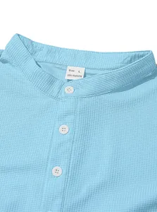 Detail of light blue waffle knit Henley shirt showing buttoned collar and size label.