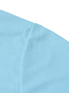 Close-up detail of light blue waffle knit fabric texture on men's casual Henley shirt