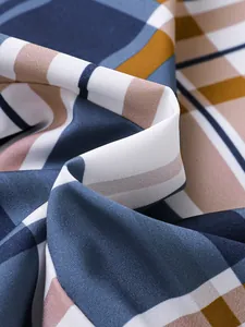 Close-up of the breathable plaid fabric texture for boys' summer shirt set