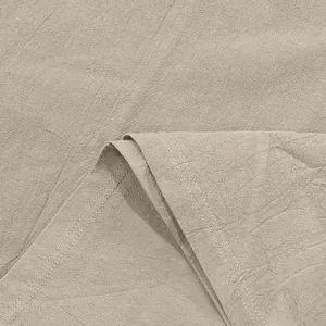 Close-up of breathable linen fabric texture with durable double-stitching detail.