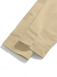 Close-up of khaki cotton linen shirt cuff showing textured fabric and button detail