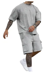 Detail view of men's gray oversized T-shirt and cargo shorts two-piece athletic set