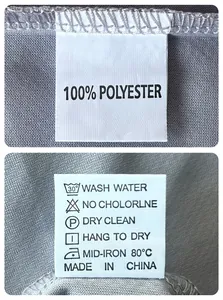 Detailed macro shot of the 100% polyester care label and washing instructions on a grey vest
