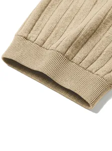 Detailed view of the ribbed cuff and vertical jacquard stripe texture on beige knit Polo