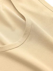 Close-up view of breathable mesh fabric texture on a beige sleeveless gym tank top for men.