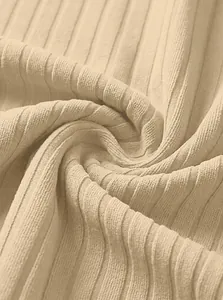 Close-up of beige ribbed jacquard knit fabric showing soft texture and breathability