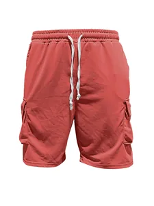 Macro view of men's summer cargo shorts with drawstring and side pockets in reddish-coral