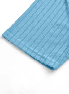 Detailed close-up of the light blue ribbed knit fabric texture on a men's polo shirt sleeve.