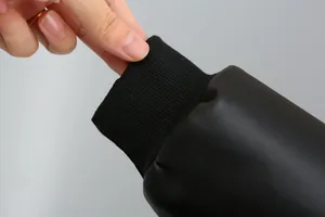 Detailed macro view of the elastic black ribbed cuff on a boy's PU leather jacket