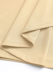 Detail shot of breathable khaki mesh fabric and reinforced stitching on a gym tank top
