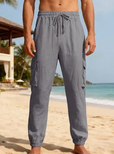 Close-up detail of grey men's linen cargo pants with multi-pockets and drawstring waist