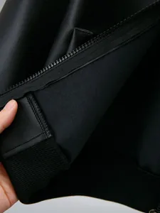 Detail of durable zipper and ribbed cuff on boys' black PU leather jacket