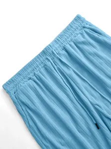 Detail view of light blue ribbed knit texture and drawstring waistband on men's shorts