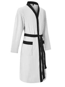 Macro view of light gray ribbed jacquard fabric and black trim on long men's bathrobe