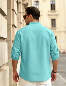 Back view of a men's light blue waffle knit long sleeve casual shirt in urban setting