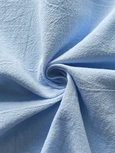 Detailed texture shot of light blue breathable linen fabric for men's casual spring shirts