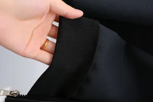 Close-up of ribbed cuff and zipper detail on black PU leather boys' jacket