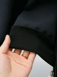 Close-up detail of black ribbed cuff on kids' PU leather jacket