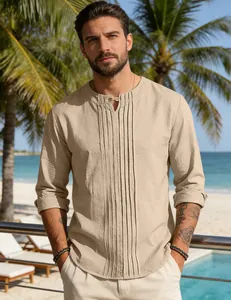 Detail view of decorative pleats and button neckline on beige linen men's shirt