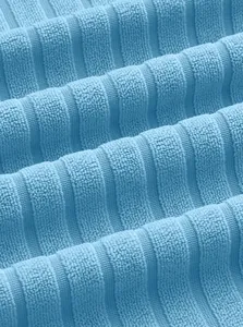 Macro view of light blue ribbed knit fabric texture for men's summer polo set