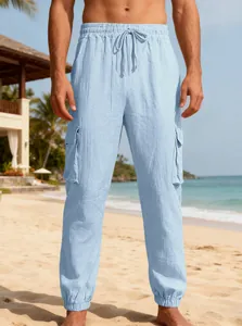 Detail view of light blue men's breathable linen cargo pants on a sunny beach