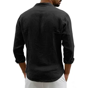 Back view of a loose black linen long-sleeve shirt with a curved hem.