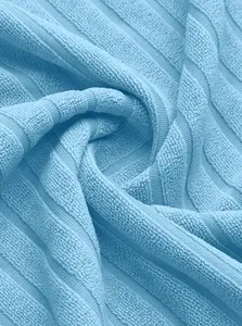 Macro detail of light blue ribbed knit fabric showing soft texture and quality finish