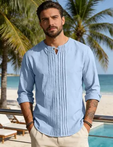 Detailed view of light blue men's linen shirt with pleated chest design