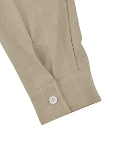 Detailed close-up view of a beige linen-blend striped shirt cuff featuring a single white button