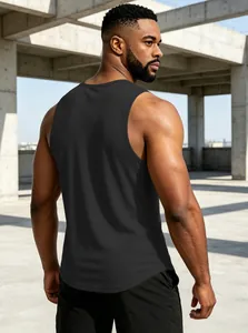 Rear view of a black quick-dry fitness tank top for men in an urban industrial setting.