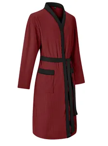 Close-up of a men's burgundy jacquard bathrobe with elegant black trim and tie-belt detail