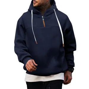 Detailed view of a men's navy blue fleece hoodie with 1/4 zip and white drawstrings