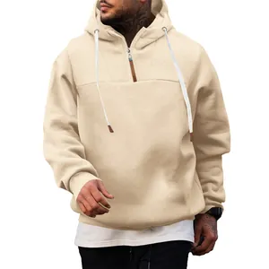 Detail of men's beige half-zip fleece hoodie with drawstrings and loose casual fit.