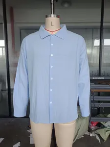 Front view of a light blue linen long sleeve shirt on a tailor mannequin