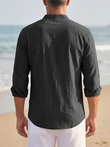 Back view of a men's dark grey striped linen shirt with stand collar at the beach