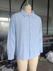 Detailed view of a light blue long-sleeved linen shirt for men on a torso mannequin.