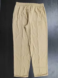 Back view of khaki men's casual trousers with elastic waist and pocket detail.