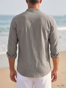 Detailed back view of a grey vertical striped linen shirt for men on beach background