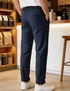 Detailed back view of men's navy blue casual straight pants in a stylish cafe setting