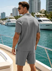 Detailed back view of men's summer grey ribbed knit polo and shorts set on a yacht deck