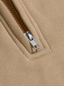Close-up detail of silver metal zipper on beige long-sleeve casual sweatshirt
