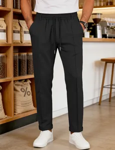 Detail shot of men's black casual trousers featuring a drawstring waist and cuffed hem.