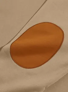 Detail view of the contrast elbow patch and stitching on a khaki retro sweatshirt