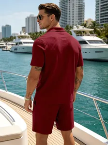 Detailed back view of men's burgundy ribbed knit polo and shorts set on a luxury yacht
