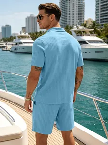 Men's light blue summer ribbed knit polo shirt and shorts set shown on a luxury boat