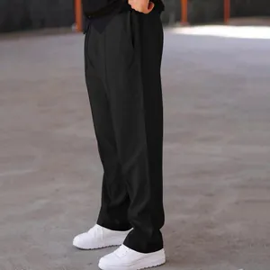 Detail view of men's loose straight-leg black casual pants in American street style