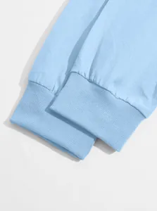 Detail view showing the high-quality ribbed cuffs of a light blue men's baseball jacket