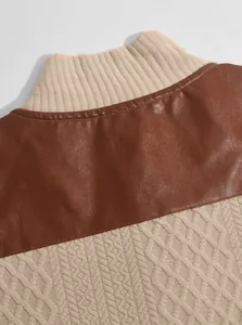Close-up detail of men's jacquard knit sweatshirt with brown leather shoulder patch