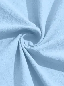 Close-up of light blue textured fabric detail for men's lightweight bomber jacket
