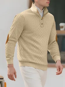 Detail showing textured jacquard knit and brown elbow patches on men's beige sweater